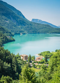 Scenic view of lake and mountains against blue sky