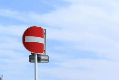 Low angle view of road sign against sky