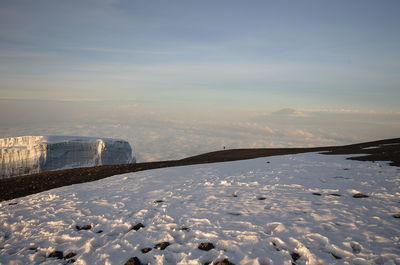 Scenic view of frozen lake against sky during winter