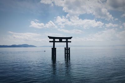 Torii gate in biwa lake against sky