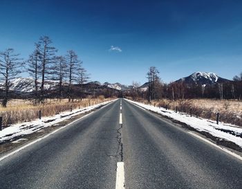 Surface level of road against sky during winter