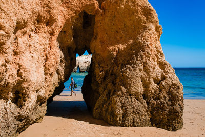 Scenic view of rock formation at beach against sky albufeira portugal
