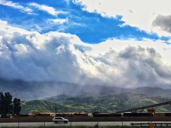 Scenic view of clouds over mountains against sky