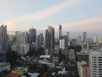 Aerial view of buildings in city against sky during sunset