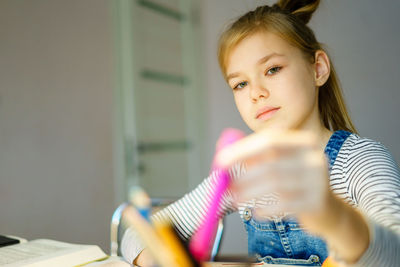 Portrait of cute girl holding camera