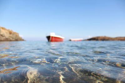 Surface level of sea against clear sky