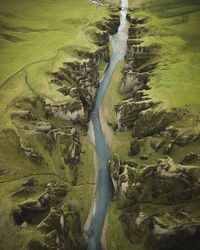 High angle view of river flowing amidst landscape