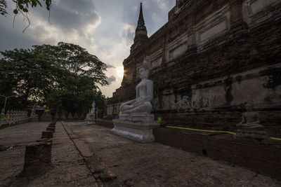 Statue of historic temple against sky