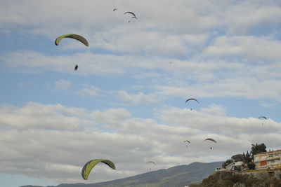 People paragliding against sky