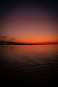 Scenic view of sea against romantic sky at sunset