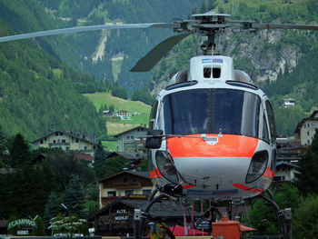 Helicopter against green mountains