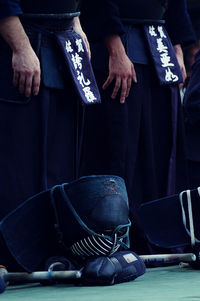 Low section of kendo players standing on floor