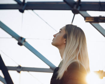 Close-up side view of young woman looking up