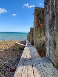 Wooden pier over sea against sky