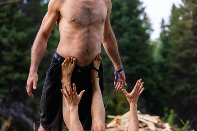 Rear view of shirtless man standing outdoors