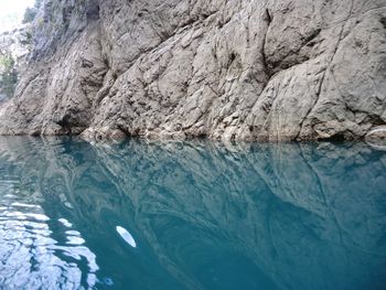 Cliff reflecting in sea