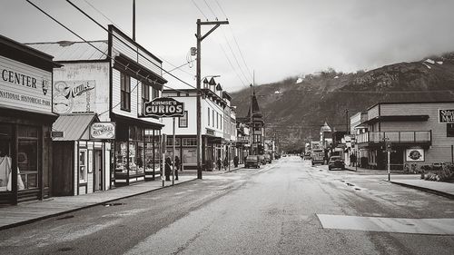 Vehicles on road along buildings