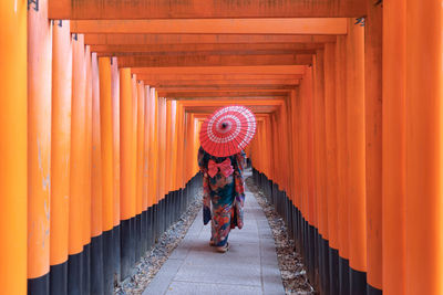 Full length rear view of woman walking in corridor