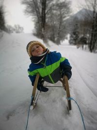 Full length of child on snow covered field