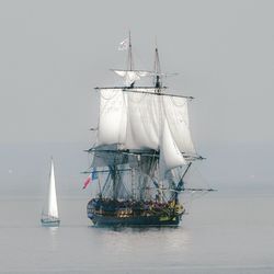 Sailboat in sea against sky