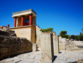 Exterior of the historic building the palace of knossos against a clear blue sky 