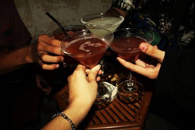 Close-up of people toasting drinks