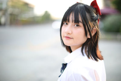 Portrait of beautiful young woman standing outdoors