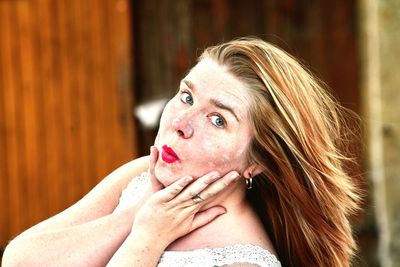 Portrait of woman making puckering at outdoors