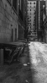Empty narrow street along buildings
