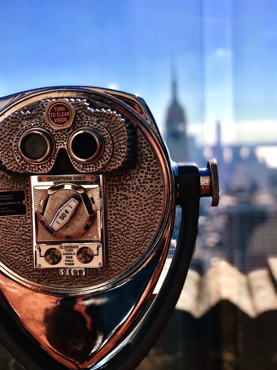 binoculars, coin operated, focus on foreground, close-up, coin-operated binoculars, sky, architecture, building exterior, day, no people, technology, built structure, metal, city, nature, surveillance, cityscape, security, outdoors, hand-held telescope, silver colored