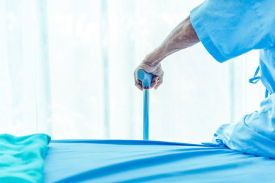 Man working on blue wall