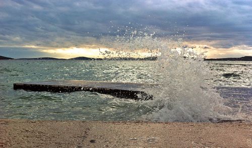 Scenic view of sea against cloudy sky