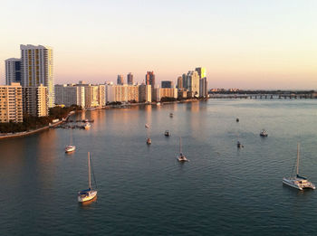 Boats in calm sea at sunset