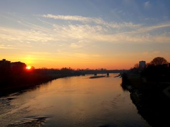 Scenic view of river against sky during sunset