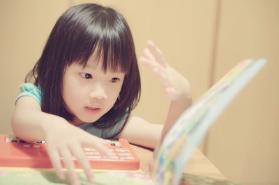 Portrait of cute girl sitting on table