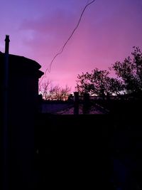 Low angle view of silhouette trees against sky at sunset