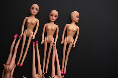 High angle view of dolls against black background