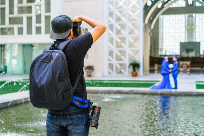 Rear view of man photographing