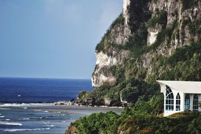 Scenic view of sea and mountains against sky