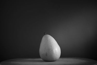 Close-up of apple on table against black background