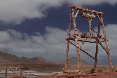 Rusty metallic structure against sky