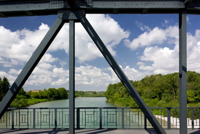 Low angle view of bridge over river against sky