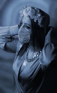 Portrait of young woman wearing mask