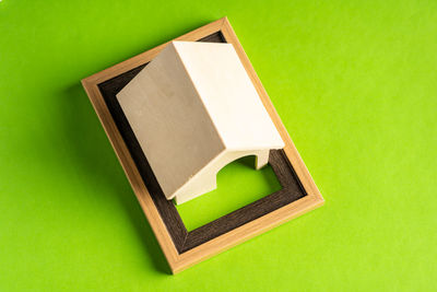 High angle view of open book on green box