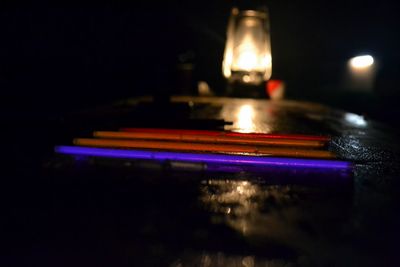 Close-up of illuminated lighting equipment in darkroom