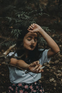 Full length of young woman lying on land