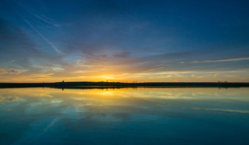 Scenic view of calm sea at sunset