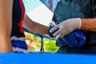 Close-up, boxing gloves tightly wrapped with cloth tape.
