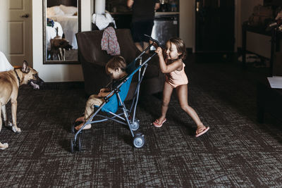 Young siblings playing in stroller in hotel room in palm springs