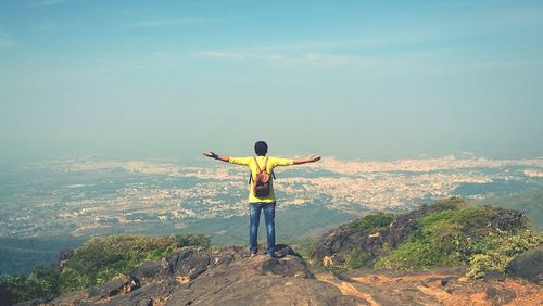 Rear view of man standing on cliff